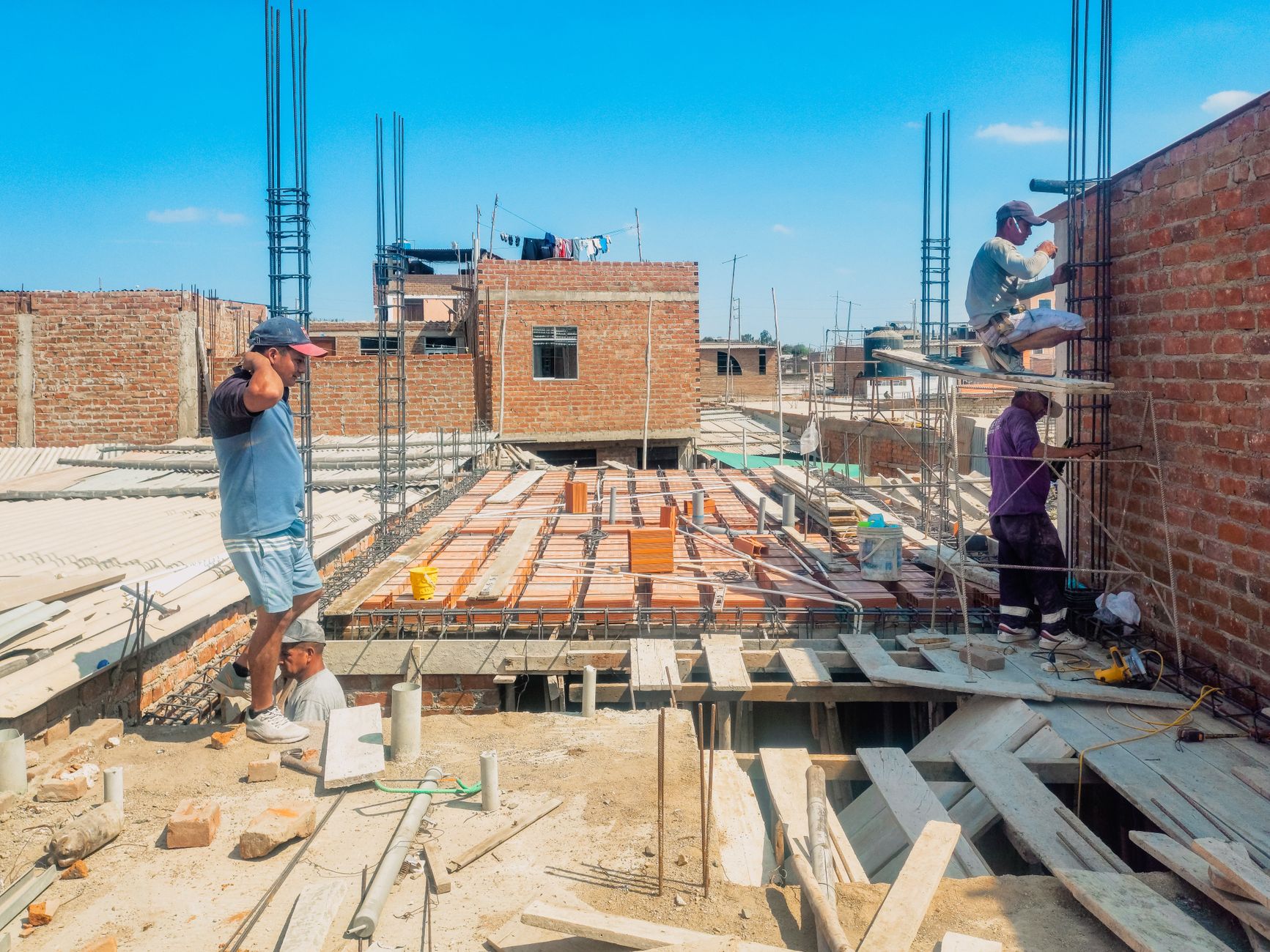 Roofing contractors working on a residential roof installation