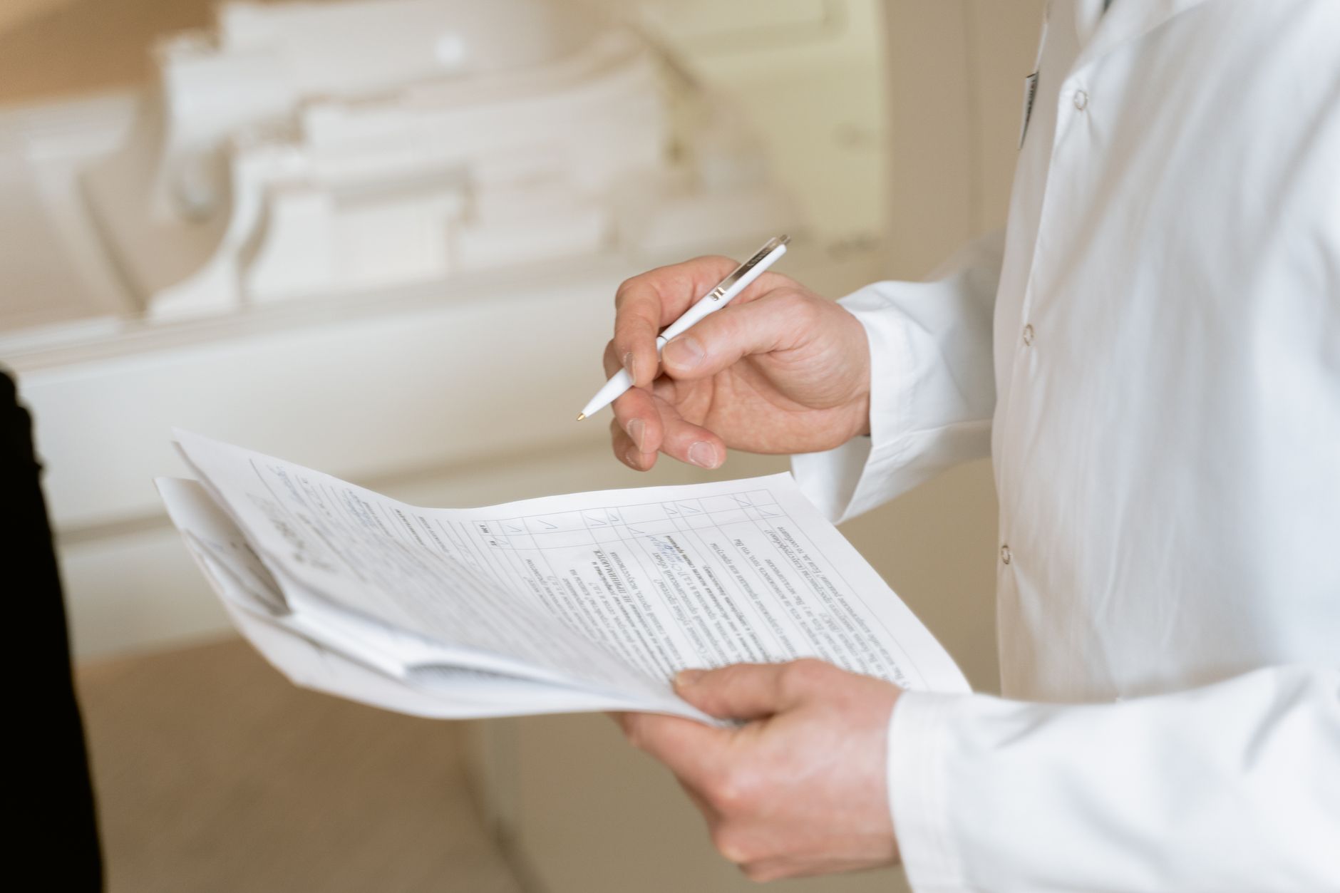 Healthcare administrator reviewing Medicaid billing paperwork and claim documents