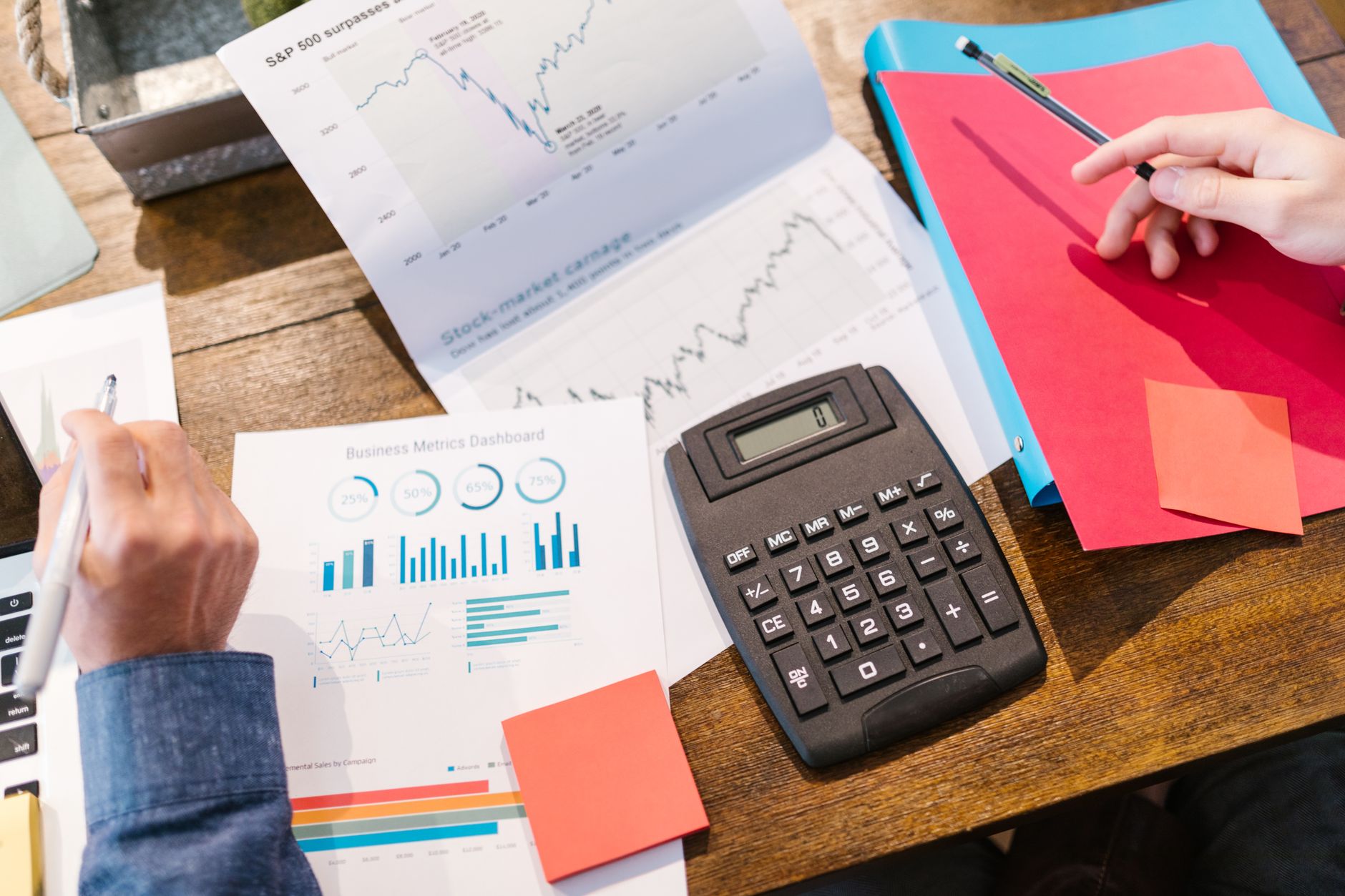 Business professionals reviewing documents and financial reports at a conference table