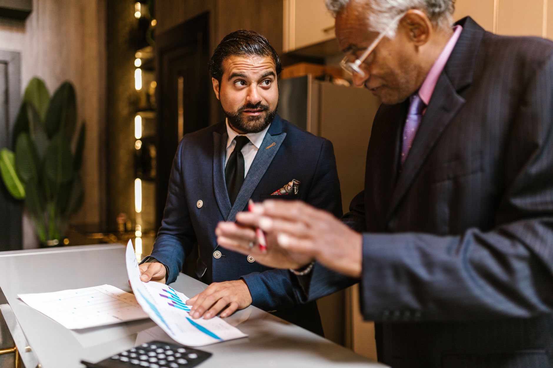 Business professionals reviewing financial documents in a corporate office setting