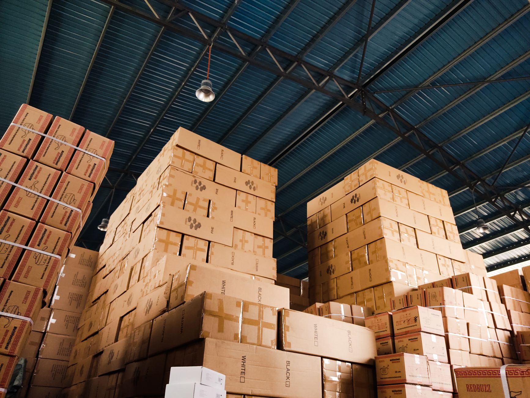Inside a freight logistics warehouse with workers and cargo