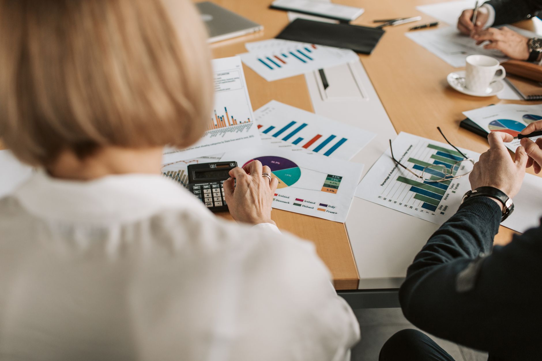 Business professionals reviewing financial documents in a conference room