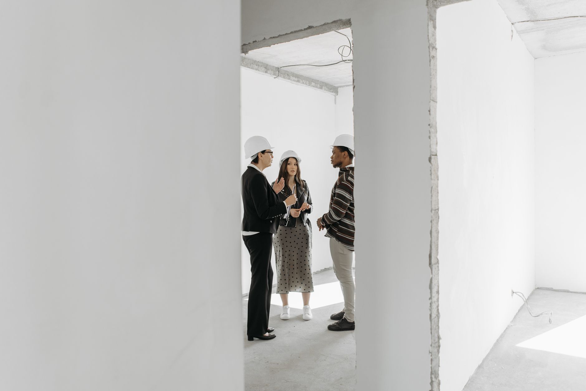 Business professionals reviewing contracts and plans in a construction office setting
