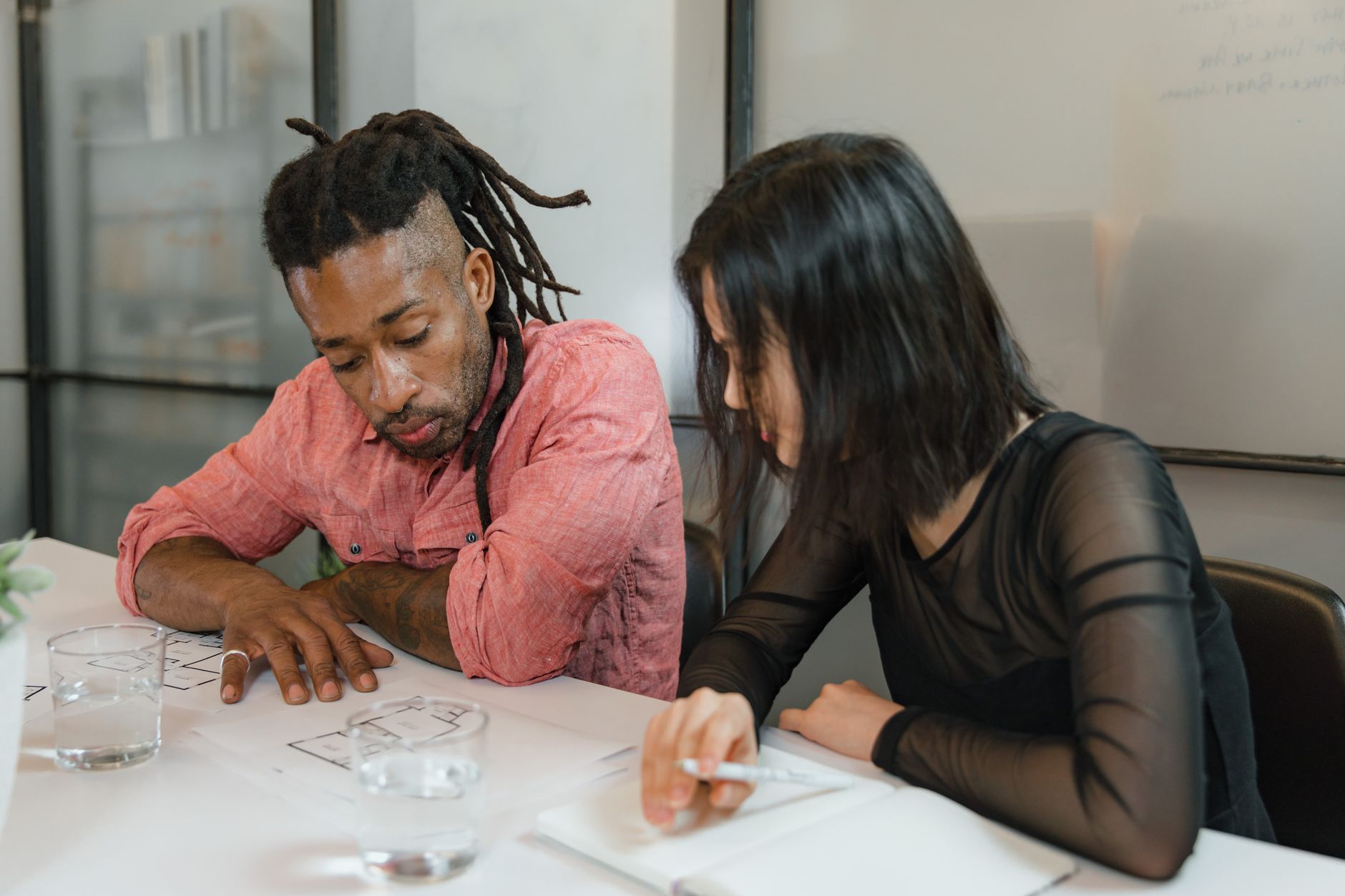 Business professionals reviewing documents in a conference room during a corporate meeting