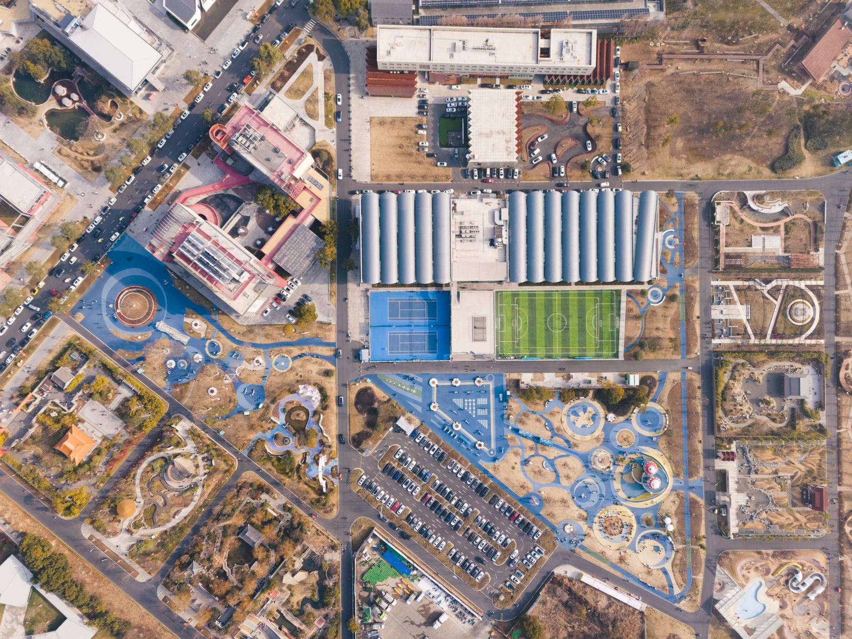 Aerial view of a landscaped urban park surrounded by city buildings
