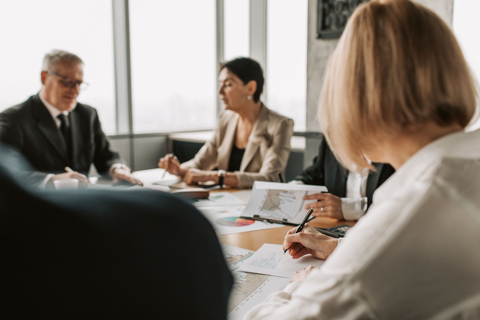 Real estate professionals reviewing documents during a mortgage closing meeting