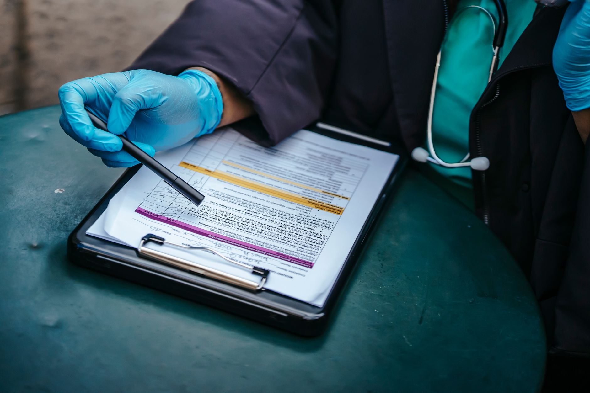 A stack of medical or business contract documents on a desk