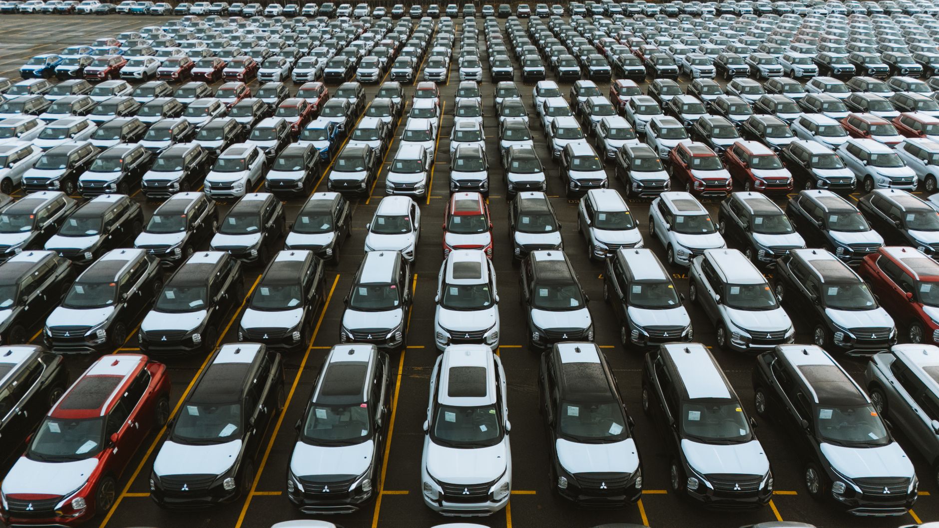 Aerial view of a regional auto dealership lot with rows of vehicles