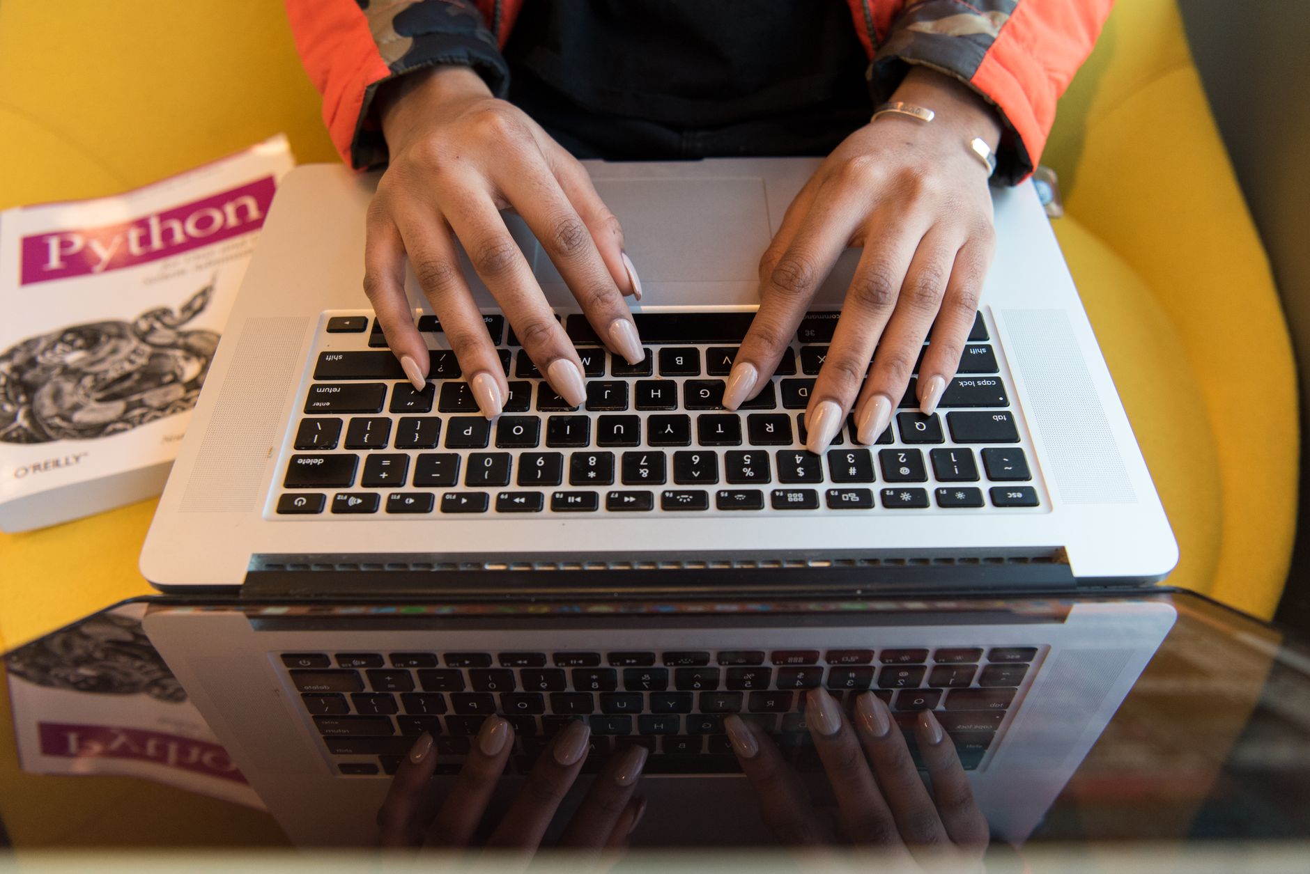 Two professionals reviewing documents at a desk during a business transaction meeting