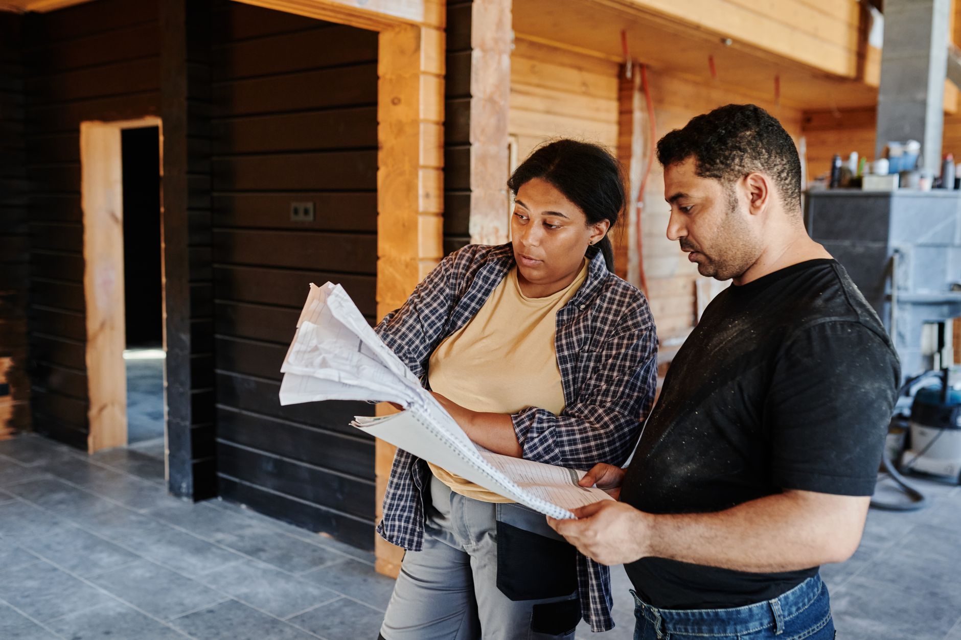 Contractor reviewing documents with a client in an office setting