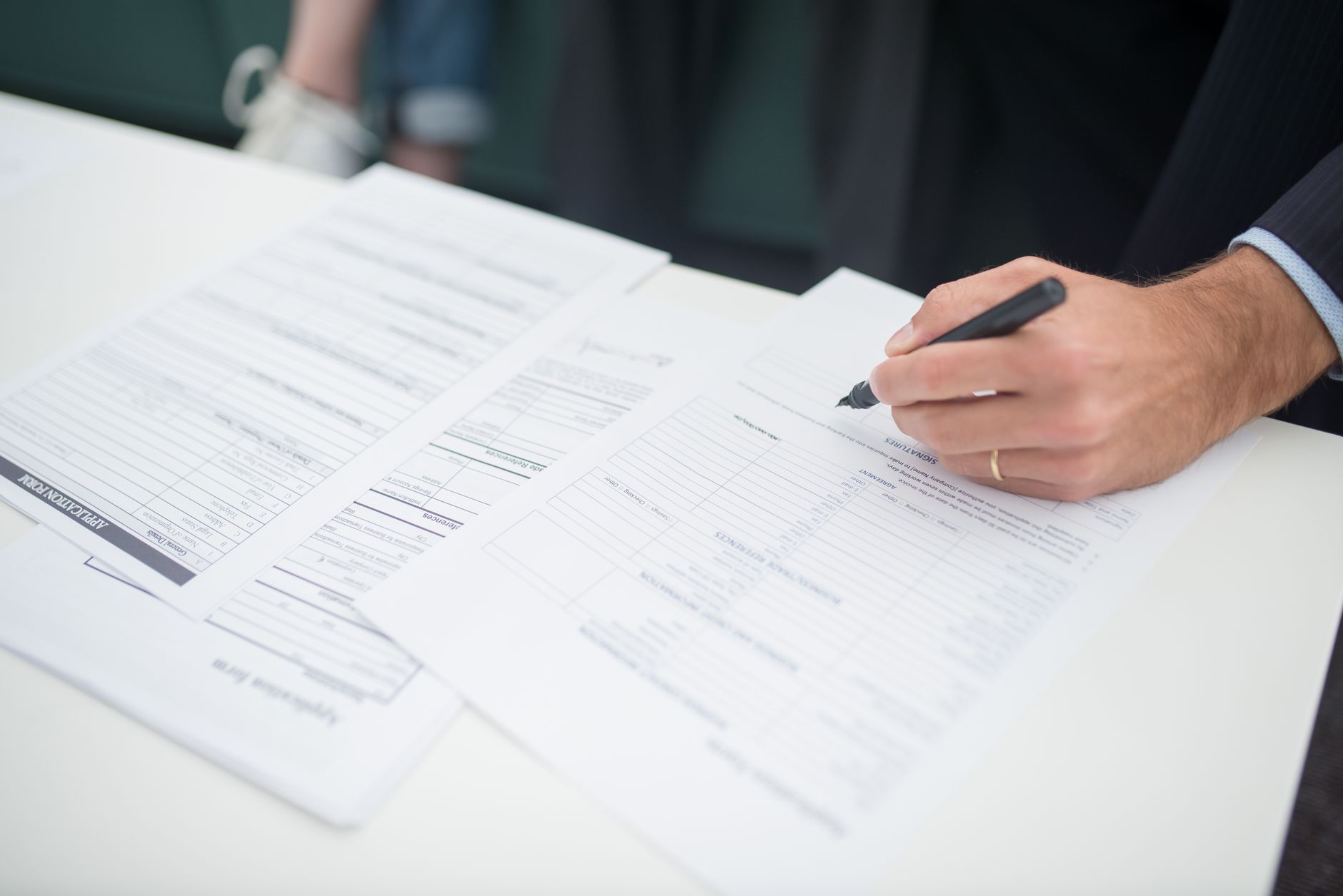 Stack of insurance and financial documents on a desk in a professional office setting