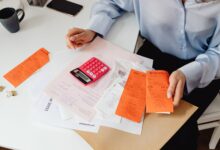 Medical billing professional working at a desk in a healthcare administrative office