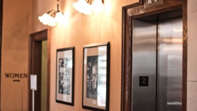 Modern elevator interior with steel doors and control panel in a commercial building