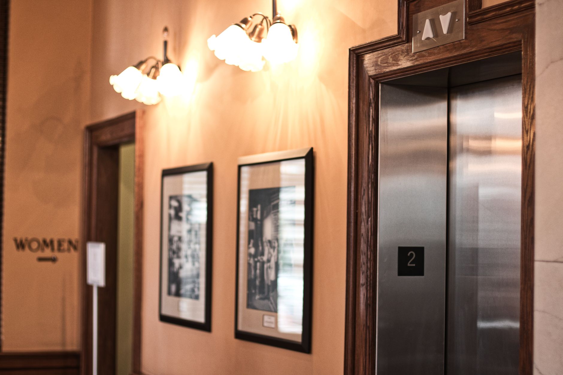 Modern elevator interior with steel doors and control panel in a commercial building