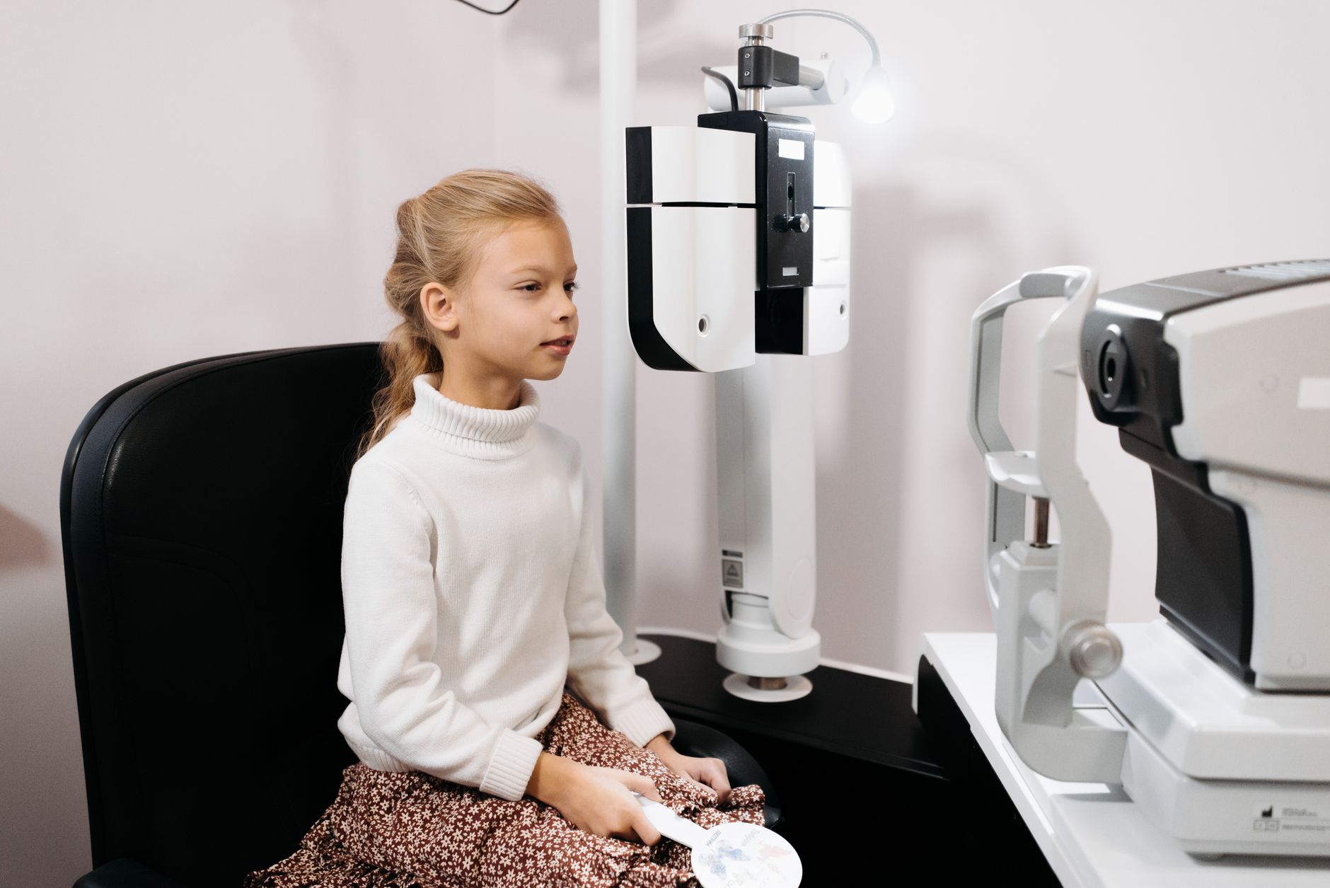 Optometrist conducting an eye examination in a modern clinic setting