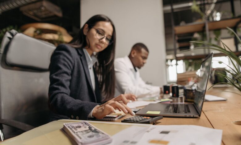 Accountants working at desks in a professional office setting