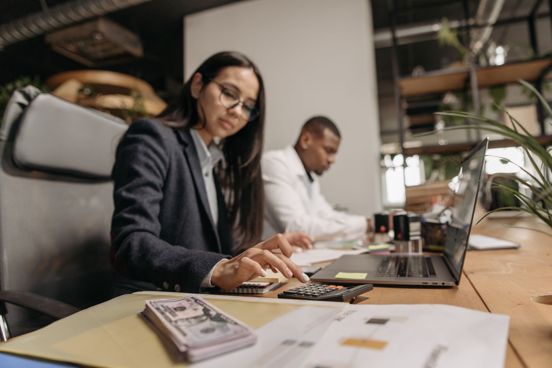 Accountants working at desks in a professional office setting