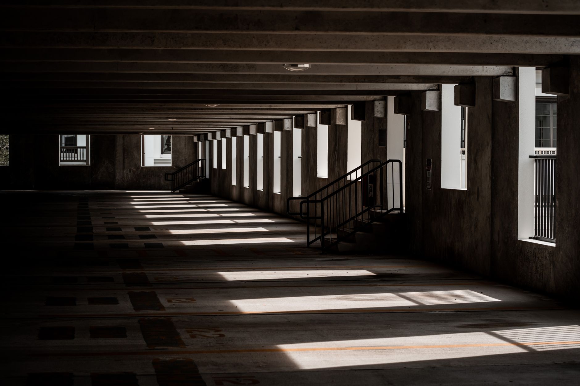 Multi-level parking garage interior with rows of empty parking spaces