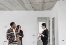 Home inspector examining a residential property exterior during a professional inspection