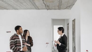 Home inspector examining a residential property exterior during a professional inspection