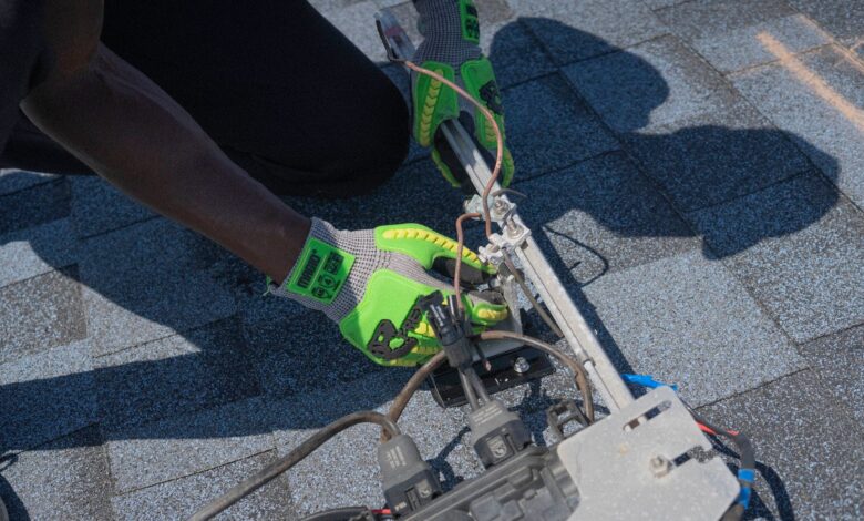 An electrician working on a residential electrical panel during a home service call