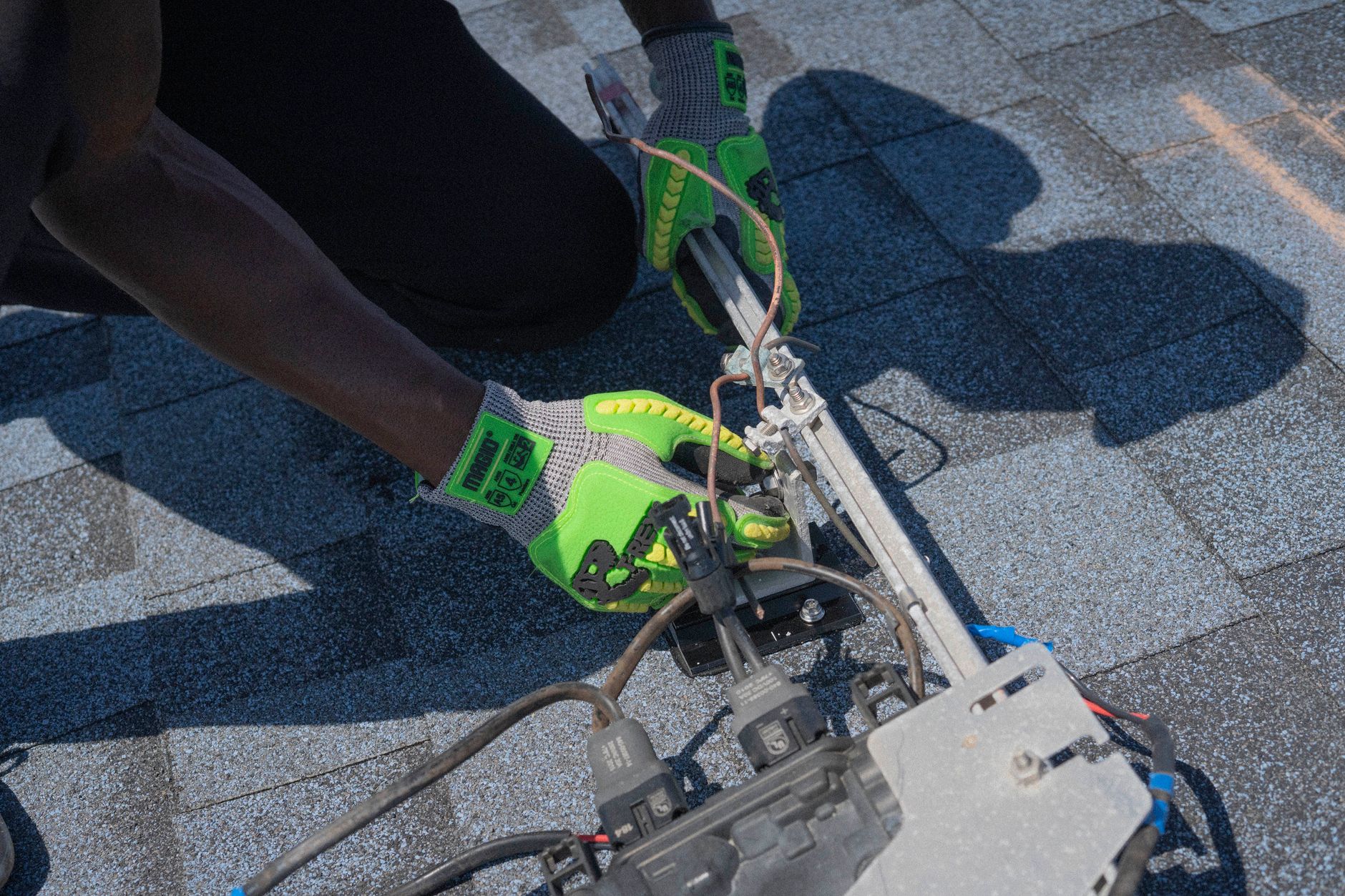 An electrician working on a residential electrical panel during a home service call