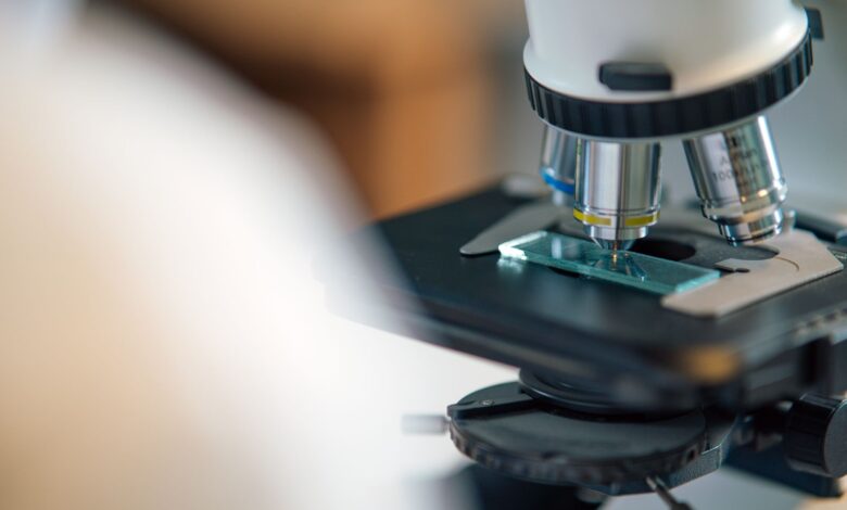 Technician working at an optical lens processing lab