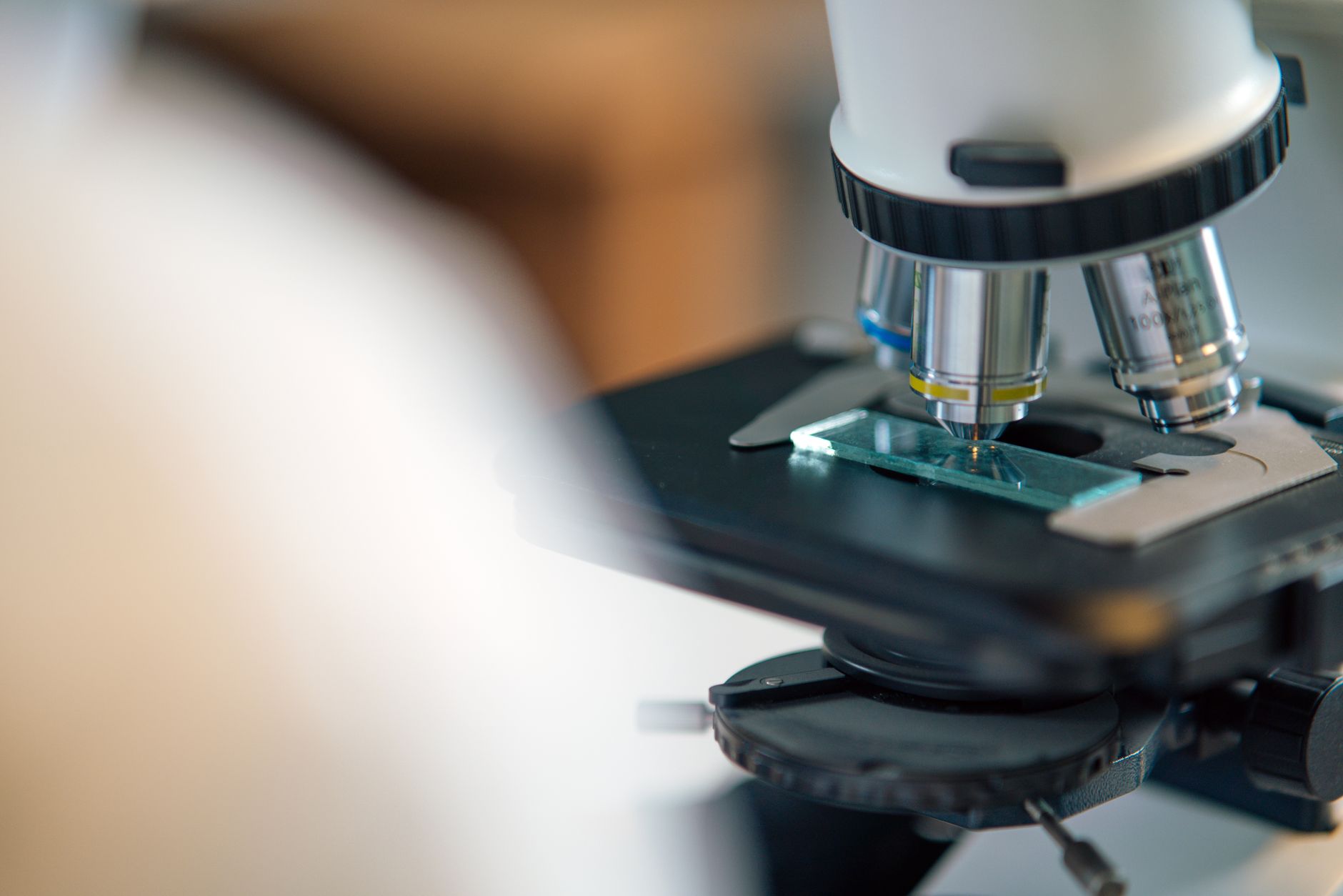 Technician working at an optical lens processing lab
