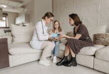 A home health aide assisting an elderly patient in a residential setting