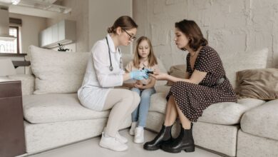 A home health aide assisting an elderly patient in a residential setting