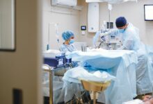 Orthopedic surgeon reviewing patient charts in a clinical setting