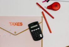A tax preparer's desk with financial documents and a calculator in a small office setting