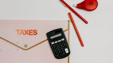 A tax preparer's desk with financial documents and a calculator in a small office setting