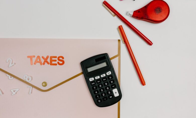 A tax preparer's desk with financial documents and a calculator in a small office setting