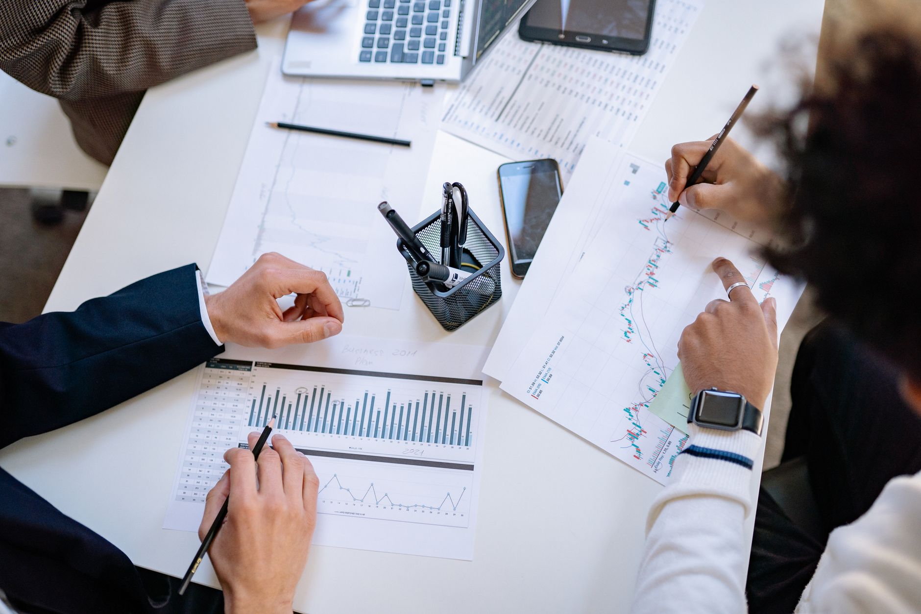 Two business professionals reviewing documents during an acquisition meeting