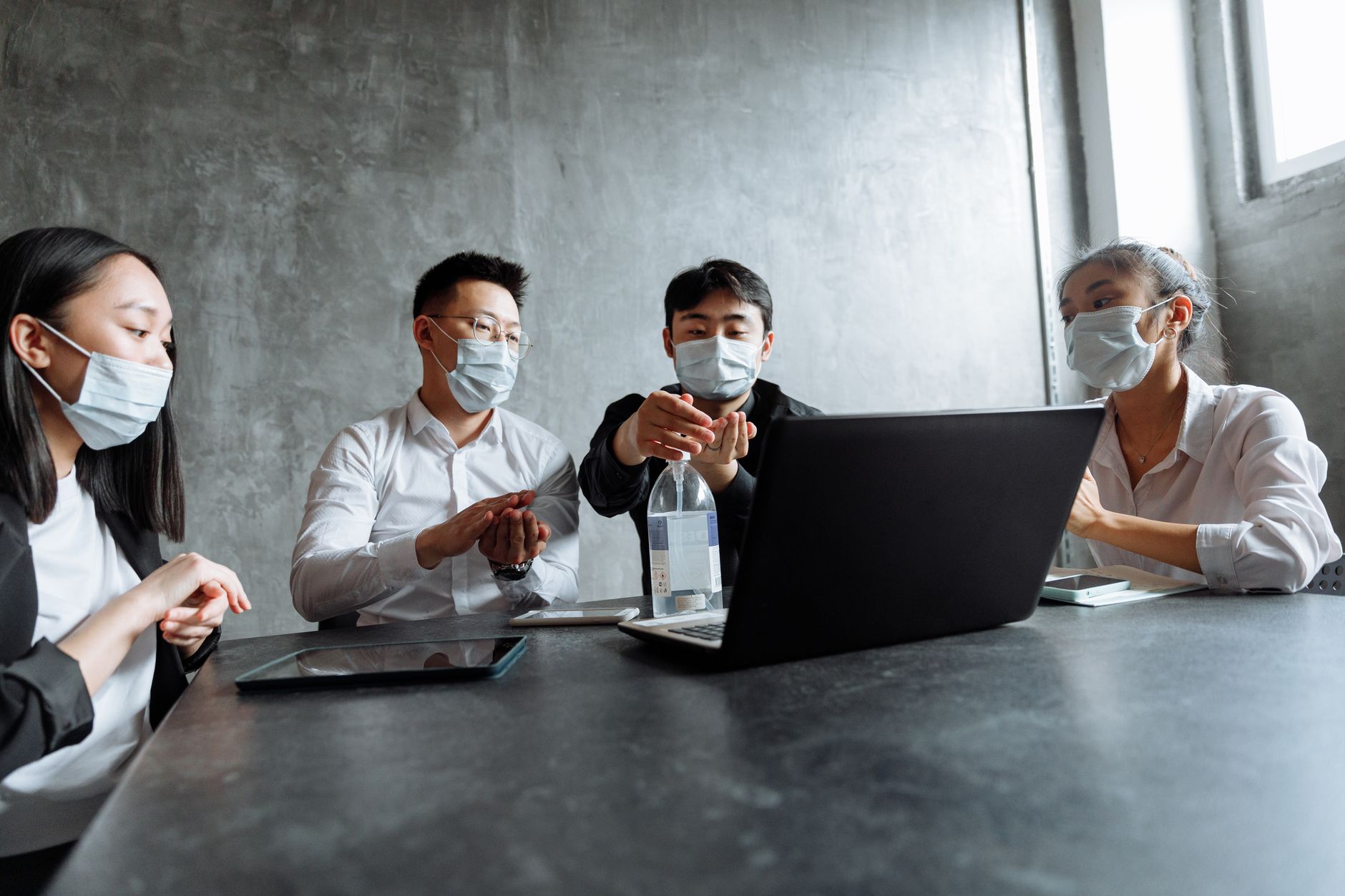 Healthcare professionals reviewing documents at a conference table during a business meeting