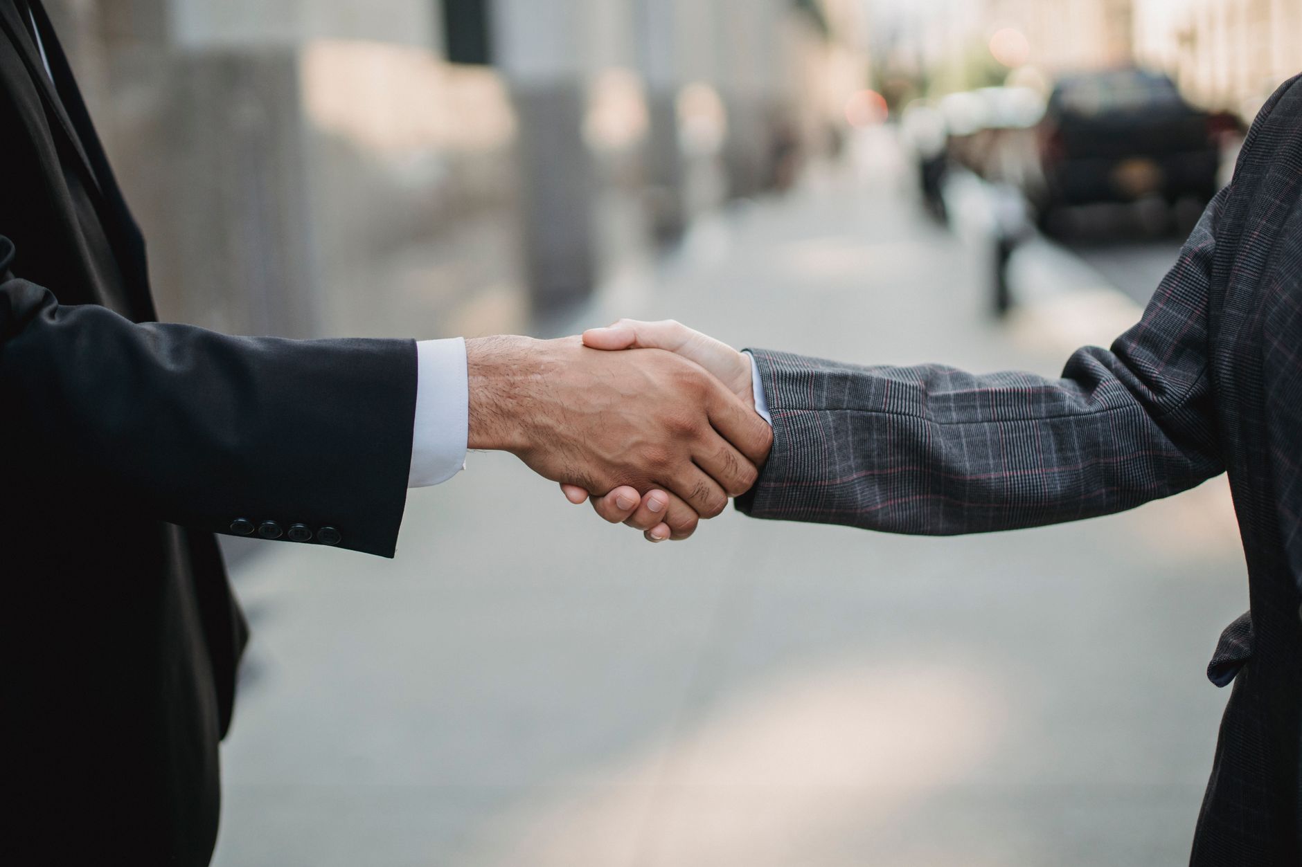 Two professionals reviewing documents during a business transaction