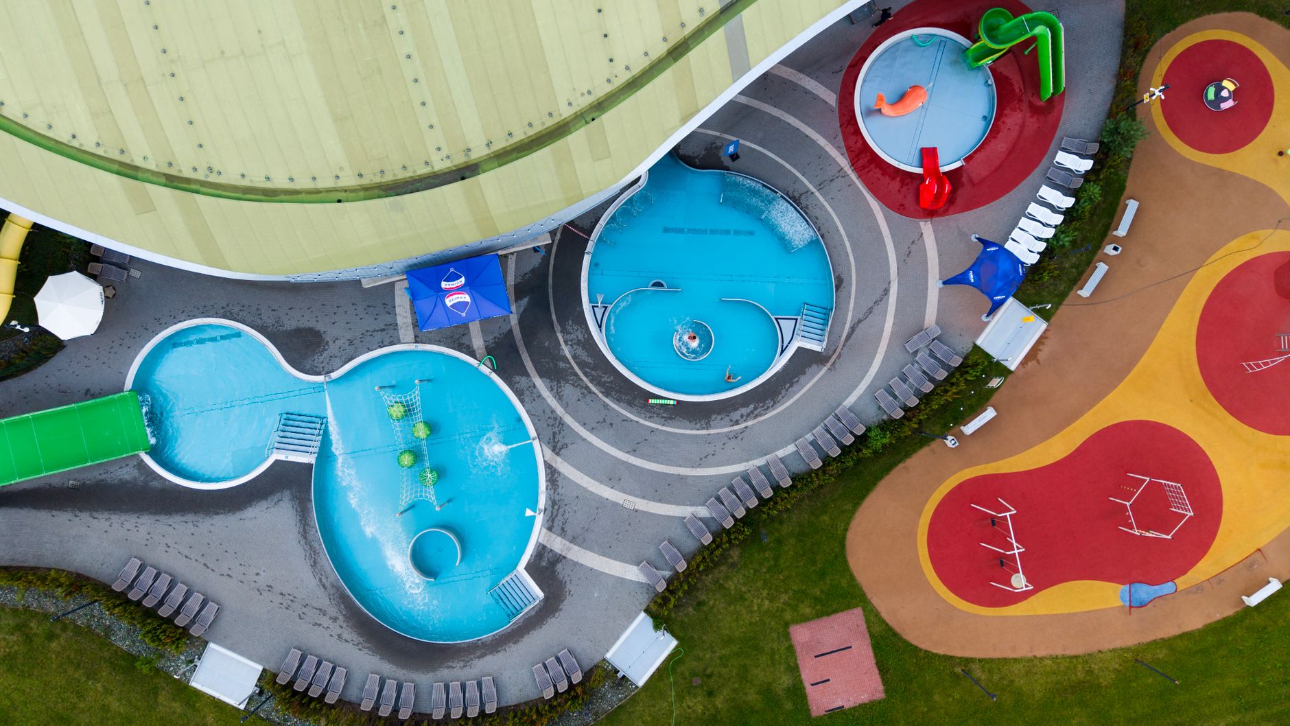 Aerial view of a residential swimming pool in a suburban neighborhood