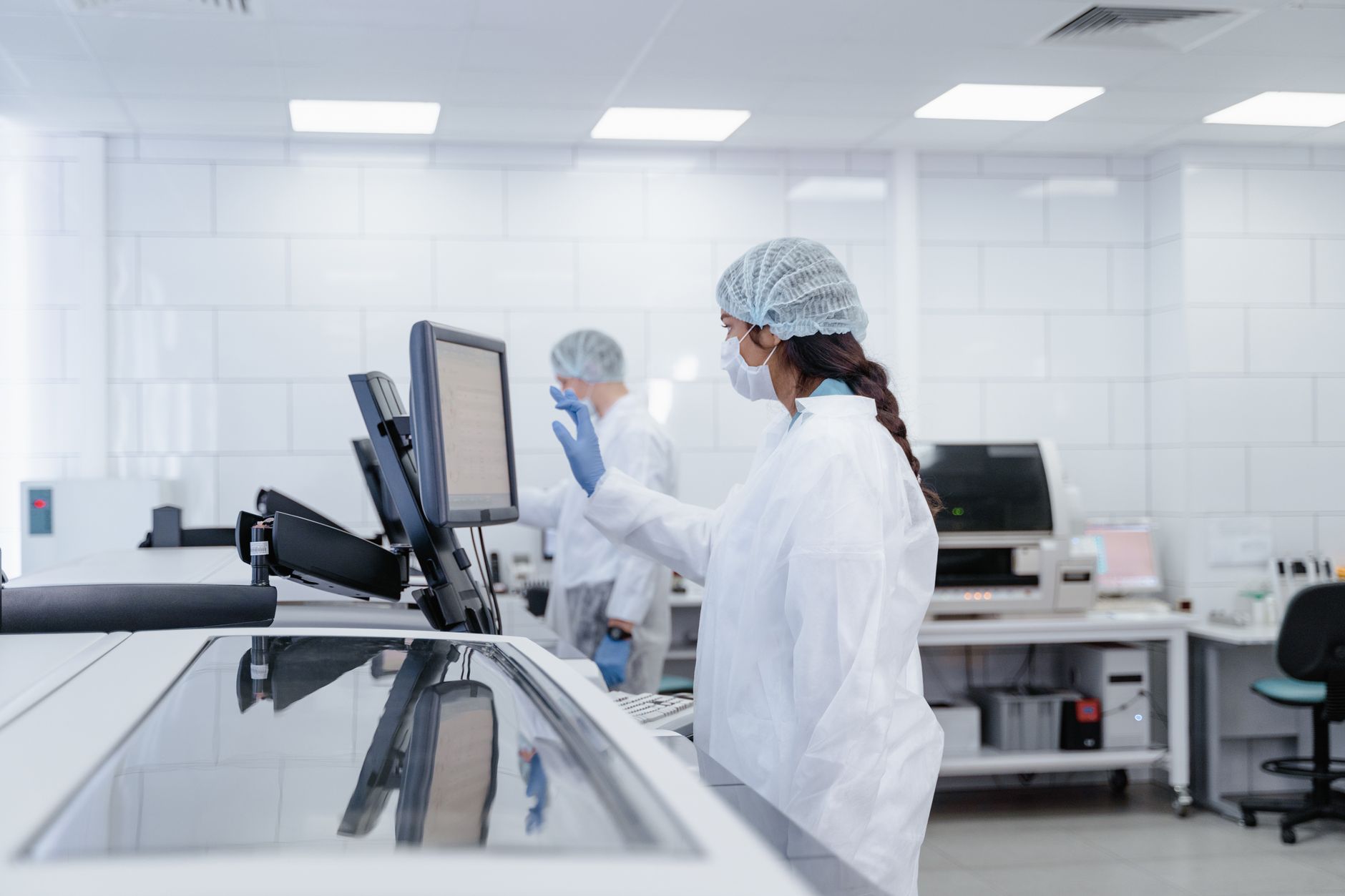 Healthcare administrator reviewing data on a computer screen in a clinical setting