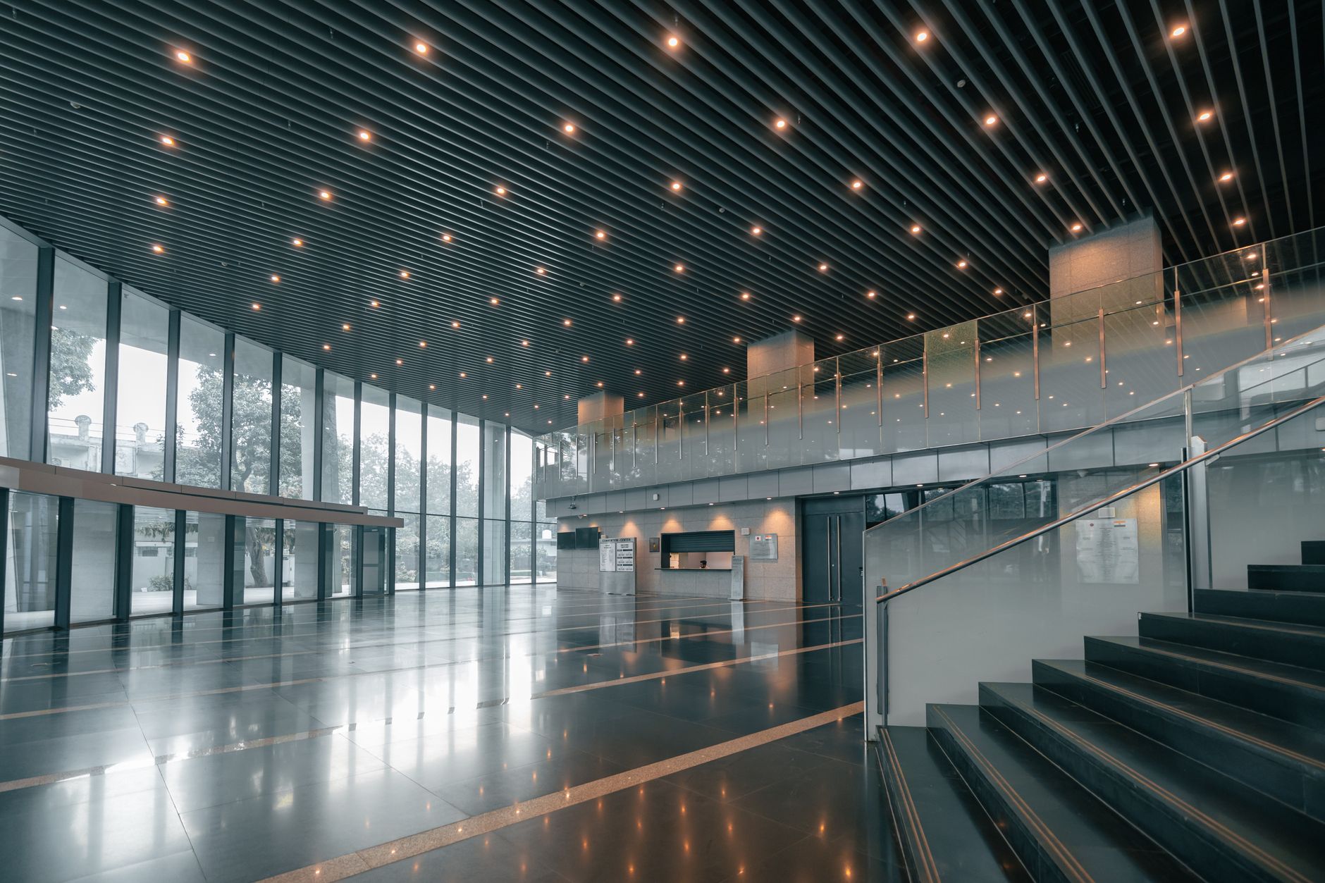 Large commercial office building lobby with elevator bank visible in background
