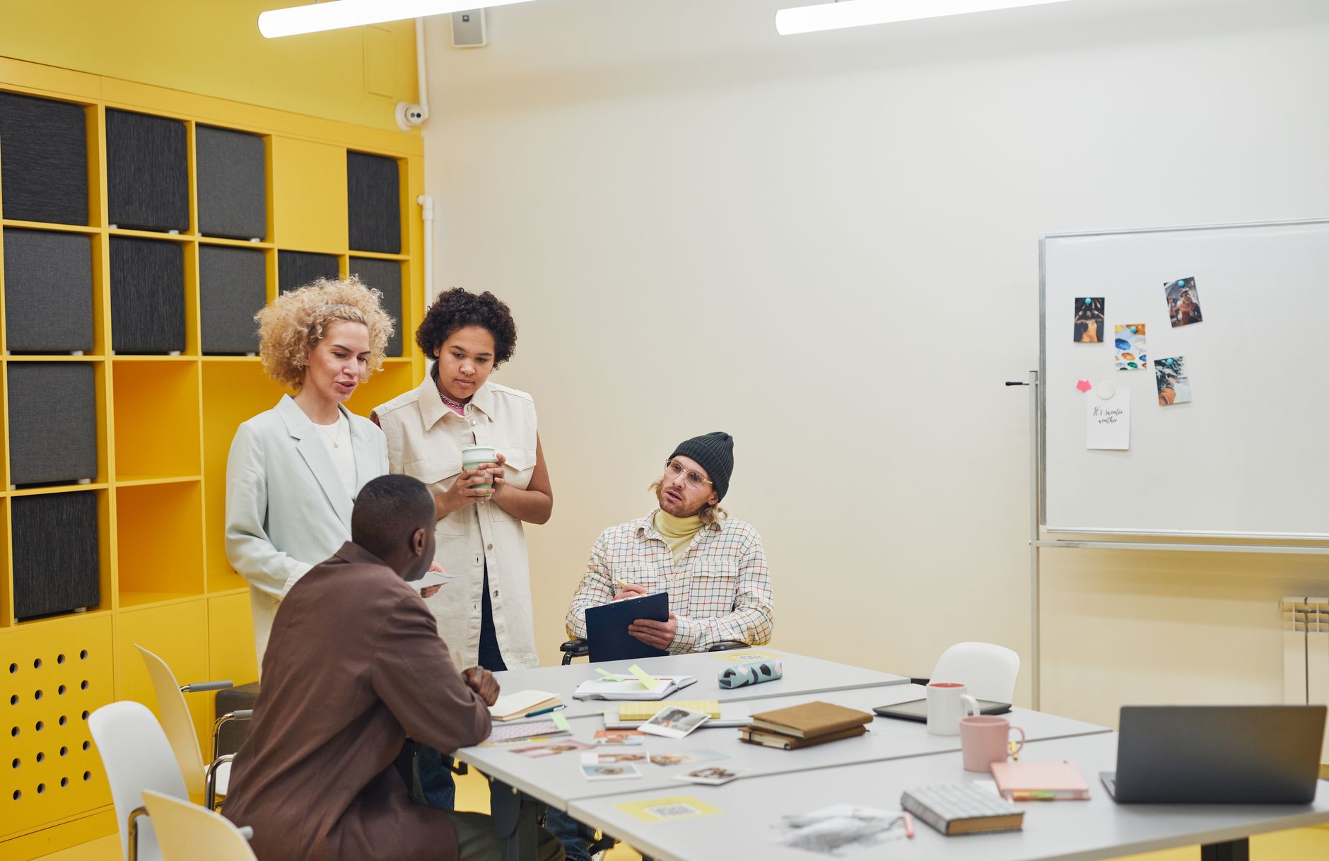 Small team of IT professionals gathered around a conference table discussing business strategy