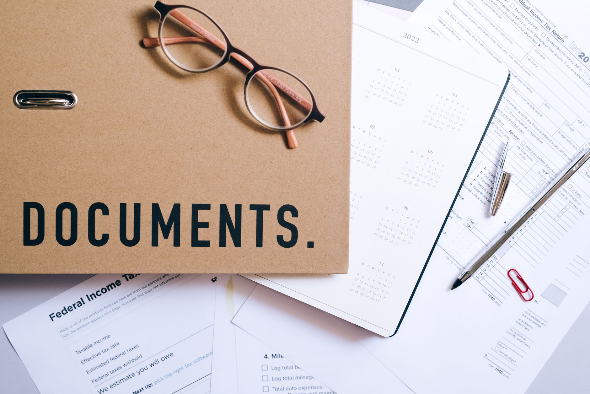 Business financial documents and reports spread across a desk