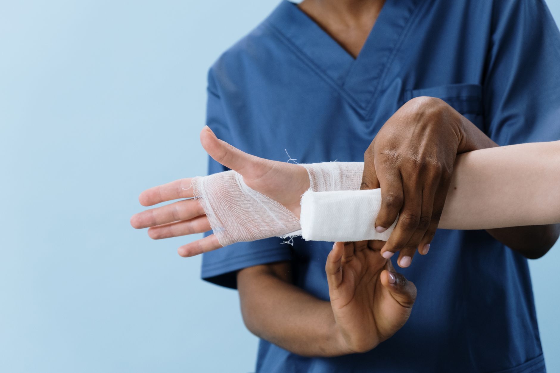 Healthcare professional providing wound care treatment to a patient in a clinical setting