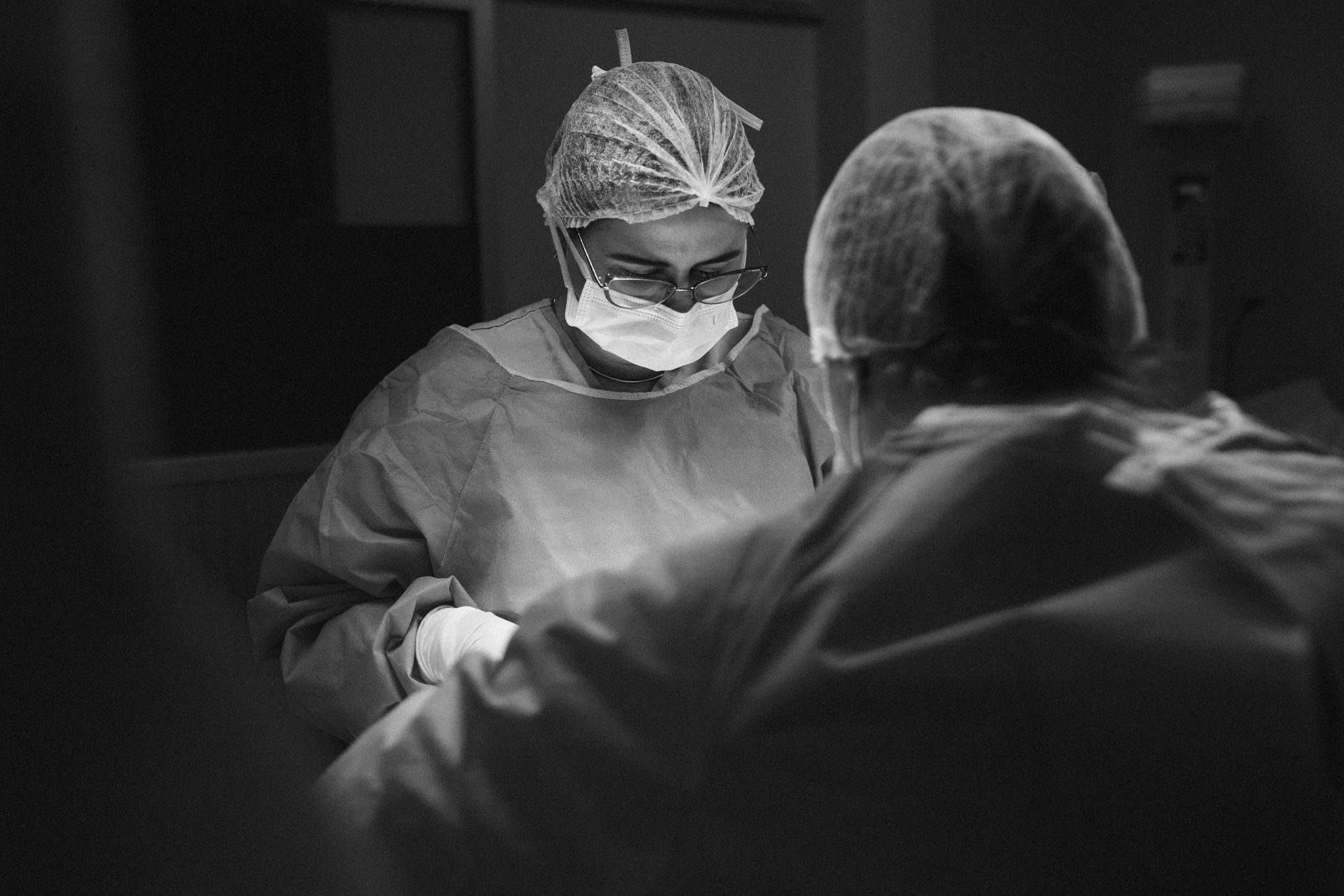 Oral or medical surgeon in scrubs standing in a clinical setting
